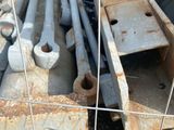a pile of old metal pipes in a fenced in area