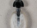 a small glass bottle with a black cap on it