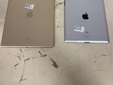 two ipads sitting next to each other on a table