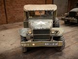 an old military truck parked in a garage
