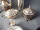 a silver plate with a silver tea pot and a silver plate with a silver tea pot and a silver plate with a silver tea pot and a silver plate