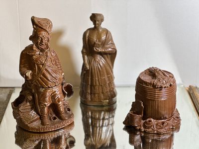 three figurines that are sitting on a glass table