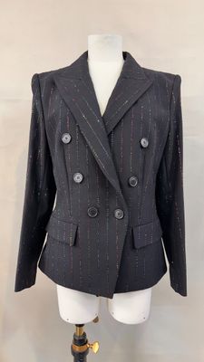 a suit on a mannequin stand with a mannequin leg