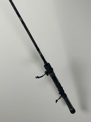 a close up of a fishing rod on a white surface