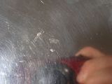a person using a knife to cut a piece of metal