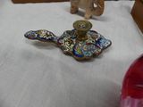 a small blue and gold candle holder on a white table