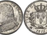 a silver coin with a crown on top of it