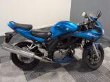 a blue motorcycle that is parked on a checkered floor