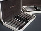 a lot of knives in a case on the table
