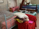 many beds in this room with a canopy over them