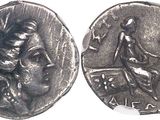 Gros plan sur une pièce de monnaie représentant une femme.