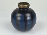 a blue and black vase with a gold top