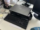 a desk with a laptop, monitor, keyboard and mouse on it