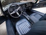 a dashboard and steering wheel of a classic car