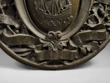 a metal plate with a design on it on a table