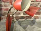 une lampe rouge posée sur une table noire