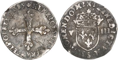 a close up of a coin with a cross on it