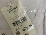 a label on a white shirt with a barcode on it