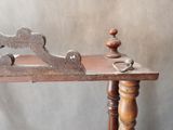 a wooden bench with a wooden handle on it