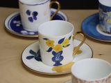 four cups and saucers sitting on a table