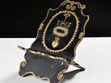 an old black and gold clock with a clock face on it