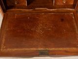 an old wooden desk with a drawer on top of it