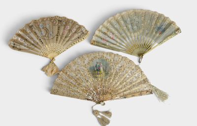 three antique chinese fans are displayed against a white background
