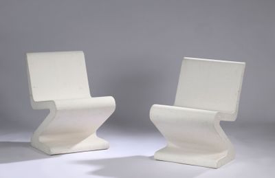two white chairs sitting next to each other on a white surface