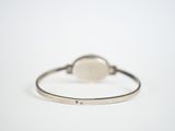 bracelet with a white stone on a thin band