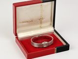 an image of a red box with a silver bracelet inside of it