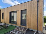 a wooden building with a picnic table in front of it