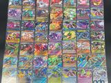 a close up of a bunch of pokemon cards on a table