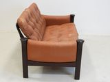 a brown leather chair with a brown cushion on it