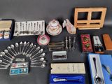 a lot of silverware and other items on the table