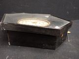 a box with a clock inside of it on a table