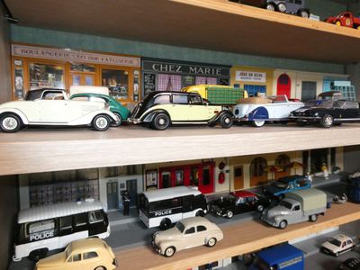 many toy cars on a shelf in a toy store