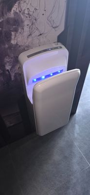 a white toilet with a blue light in it