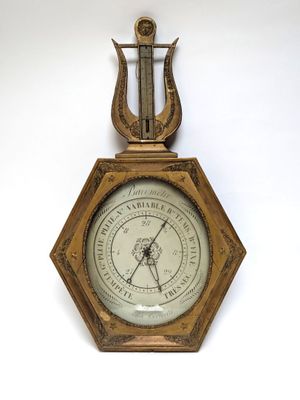 an old clock with a harp hanging on a wall