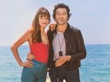 they are posing for a picture on a pier by the ocean