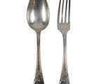 two silver spoons and a fork on a white background