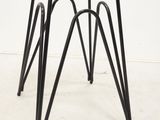 an image of a black stool with a wooden seat and metal legs