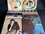 quatre disques vinyles de styles et de tailles variés sur fond noir