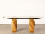 a round glass table with wooden legs and a glass top