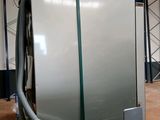 a large stainless steel refrigerator sitting in a warehouse