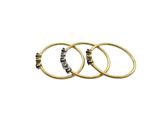 a set of three gold rings with black and white stones