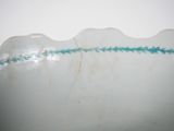a close up of a white bowl with a blue line on it