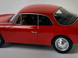 a red car that is sitting on a white surface