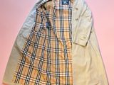 a beige trench coat on a pink background