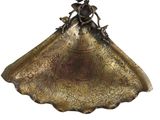 an image of a gold plate with a flower decoration on it
