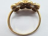 a close up of a gold ring on a white surface